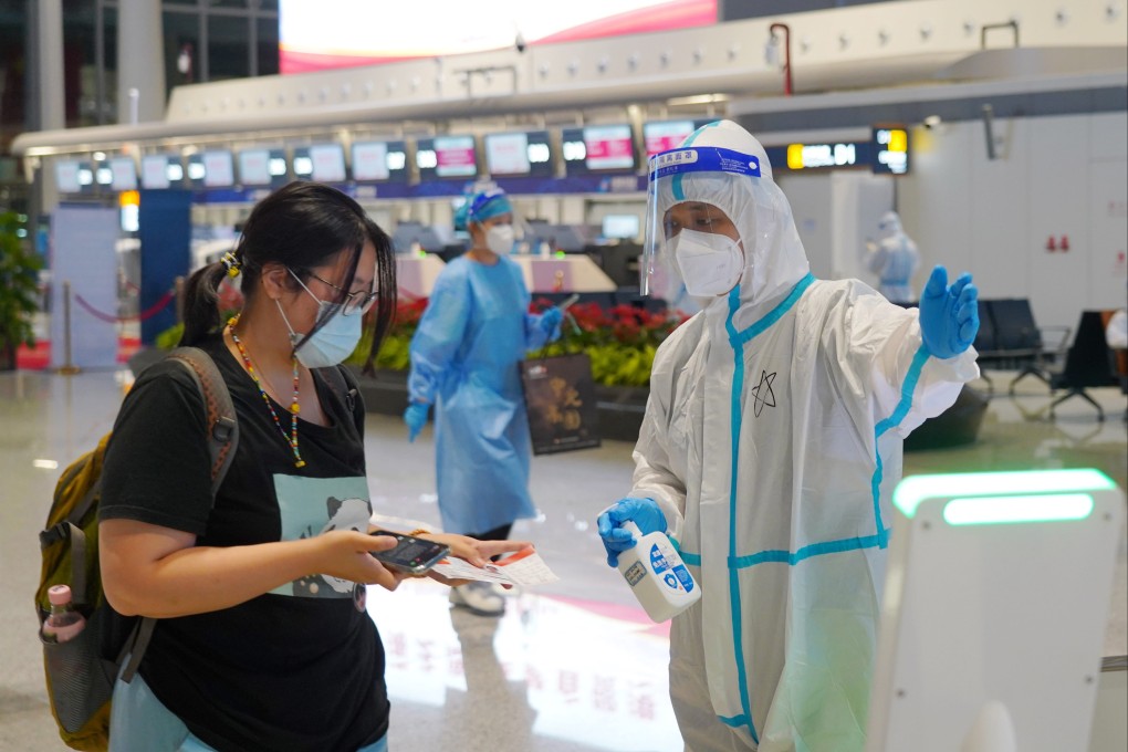 A tourist undergoes security checks before catching her flight home at Haikou Meilan International Airport in Hainan. Photo: Xinhua