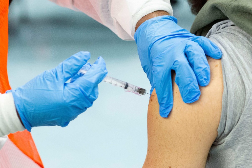 A man receives a vaccine against Covid-19. Photo: AFP