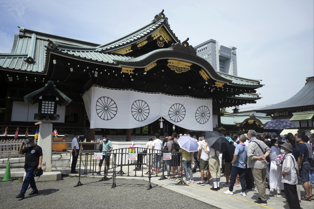People pay respects to Japan’s war dead at the Yasukuni Shrine in Tokyo on Monday. Photo: AP