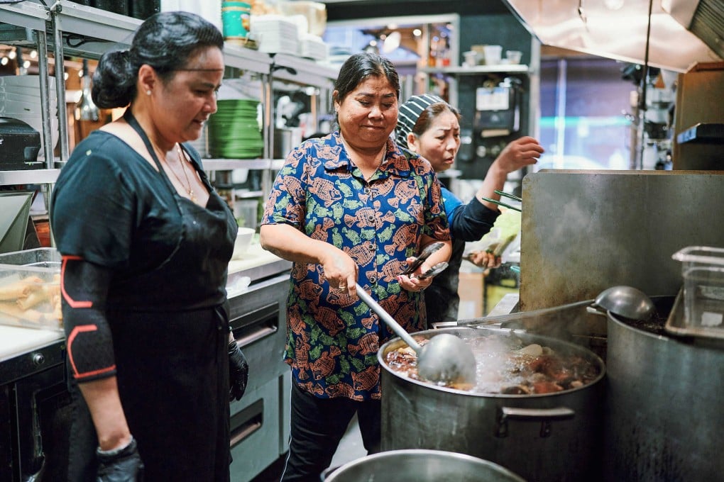 Vietnamese food vendor Nguyen Thi Thanh (middle), dubbed the “Lunch Lady” by Anthony Bourdain, in the kitchen at Lunch Lady, a Vancouver restaurant named after her and on whose opening she collaborated. Photo: Niko Myyra