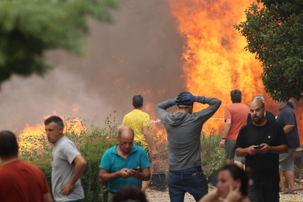 Residents are evacuated from a forest fire in the Anon de Moncayo, Spain on Saturday . Photo: EUROPA PRESS / DPA