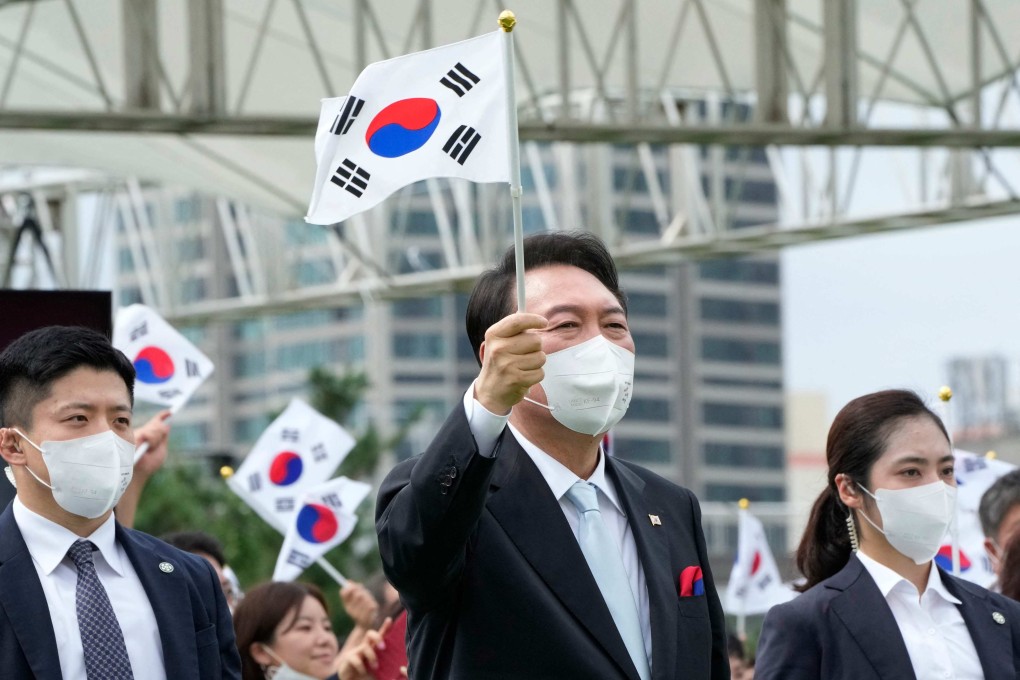 President Yoon Suk-yeol waves a South Korean flag during a ceremony in Seoul on Monday to mark Korean Liberation Day. Photo: AFP