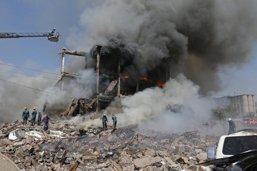Firefighters at work after explosions ripped through a fireworks warehouse in a shopping mall in Yerevan, Armenia on Sunday. Photo: Photolure via Reuters