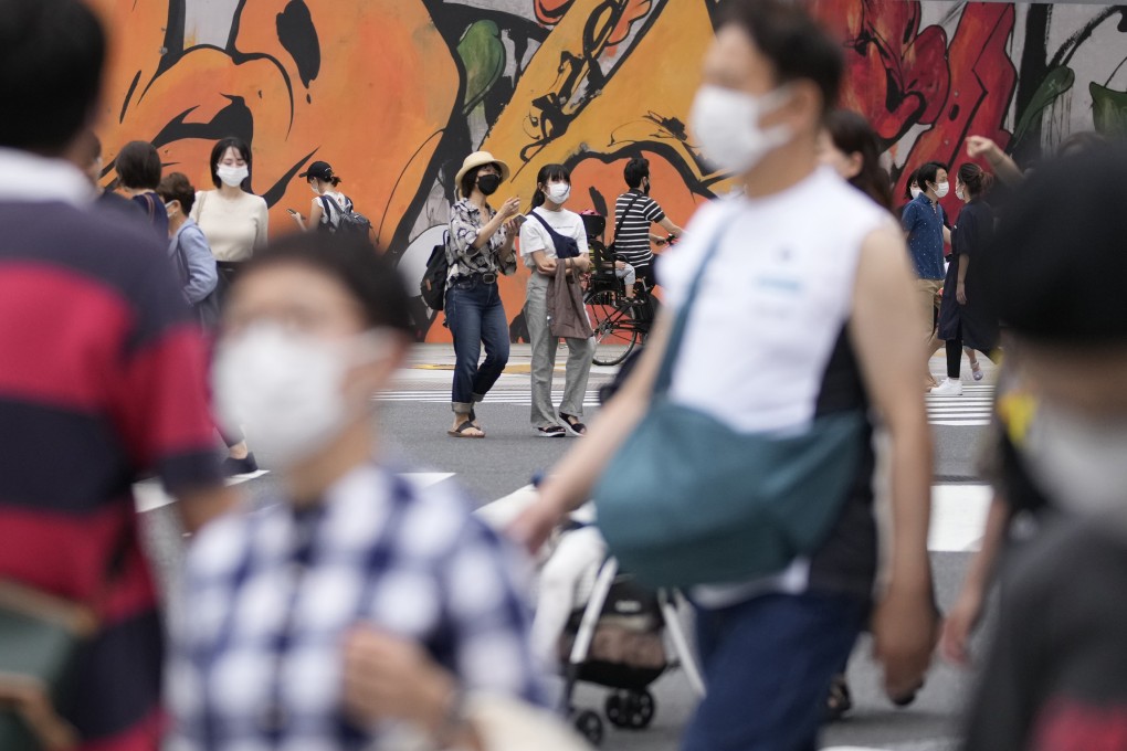 People wearing face masks walk across a pedestrian crossing in Tokyo. Women in their 20s accounted for the largest increase in suicides amid the pandemic, the Japanese study found. Photo: AP