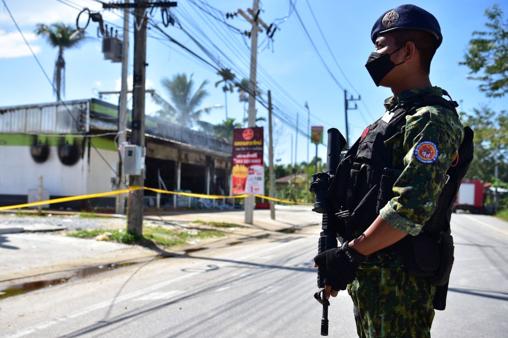 A Thai soldier guards a convenience store and petrol station damaged after an overnight attack in Cho-airong district, southern Thailand’s Narathiwat province, on Wednesday. Photo: AFP