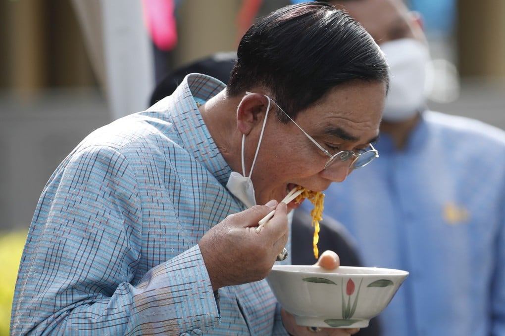 Thai Prime Minister Prayut Chan-o-cha tastes the traditional northern dish of Khao Soi. The dish was named the best soup in the world by a food website. Photo: EPA-EFE