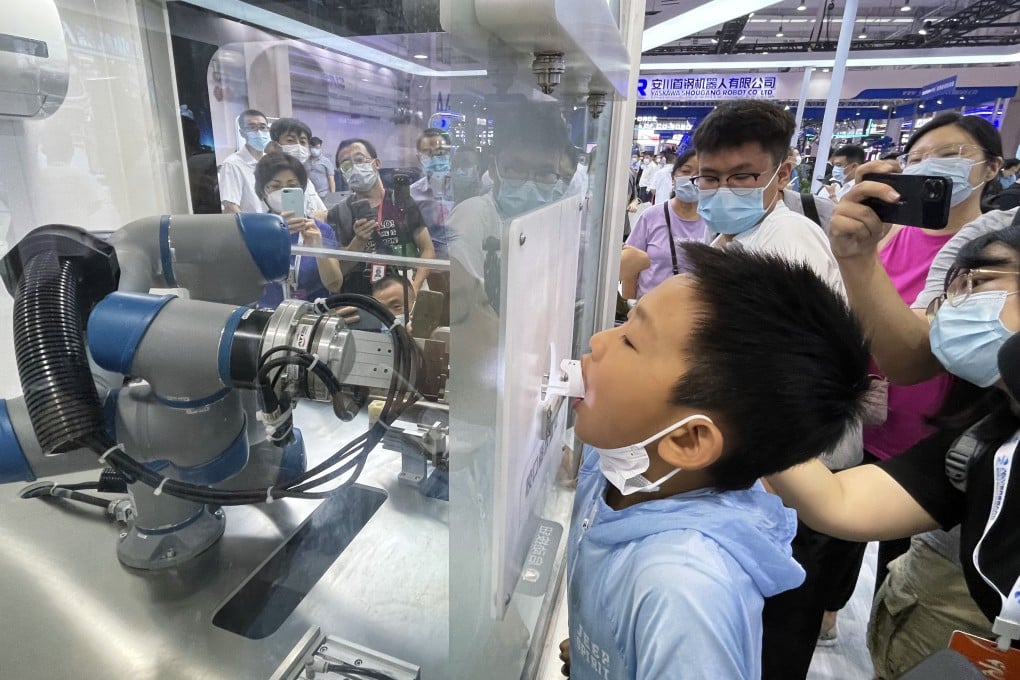 World Robot Conference 2022 attendees flock to see a machine that collects Covid-19 oral swab samples on August 18, 2022. This automaton was built by Siasun Robot & Automation Co, a Shenzhen-listed company under the Chinese Academy of Sciences. Photo: Simon Song
