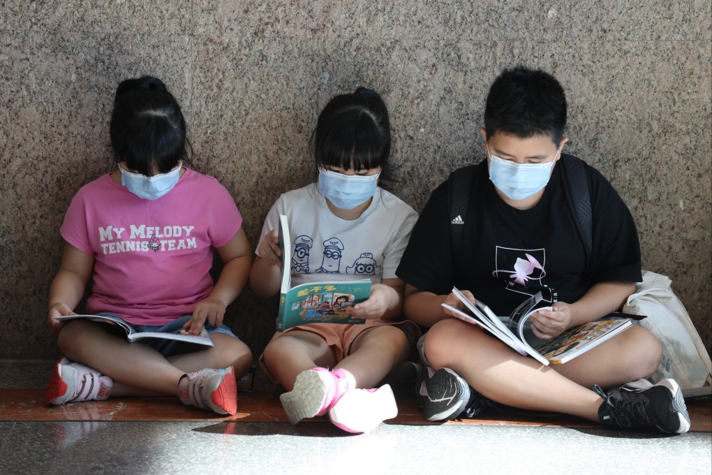 Children read at the Hong Kong Convention and Exhibition Centre during the Hong Kong Book Fair in July last year. Language classes in Hong Kong focus too heavily on tests, but test results don’t necessarily mean proficiency in daily use. Photo: Nora Tam