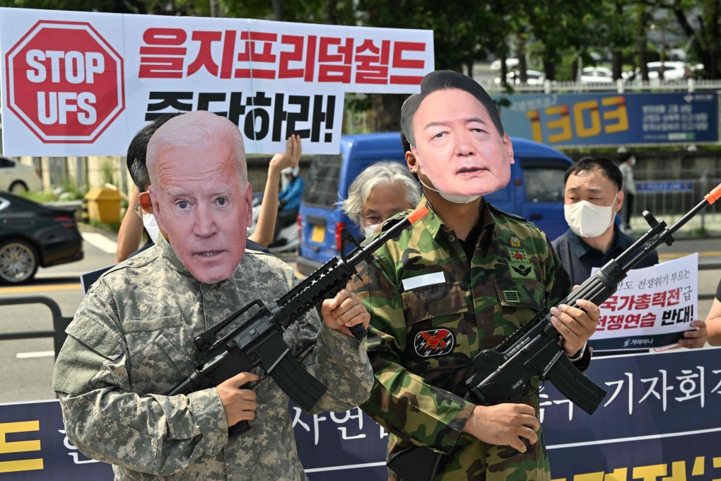 Anti-war activists wearing Joe Biden and Yoon Suk-yeol masks protest against US-South Korea military drills, near the presidential office in Seoul on August 4. Photo: AFP