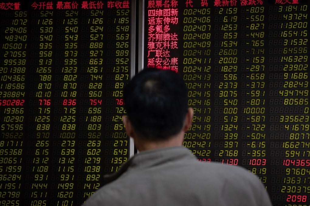 A person watches an electronic board displaying the stock index and prices at a securities brokerage in Beijing on May 6, 2019. Photo: EPA-EFE