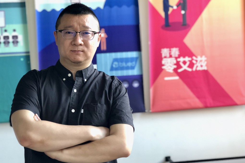 Ma Baoli, who goes by the pseudonym Geng Le,  stands in the hallway at the Blued Headquaters in Beijing on May 29, 2018. Photo: SCMP/Xinyan Yu
