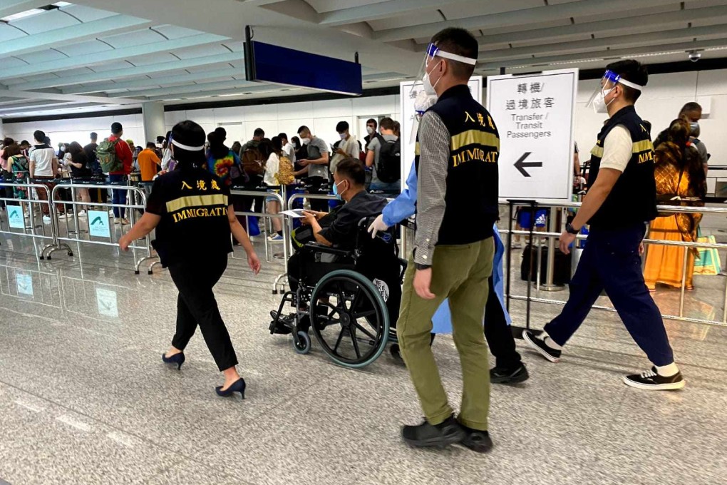 Immigration staff at the airport escort a returnee believed to be a rescued victim of human trafficking. Photo: Handout