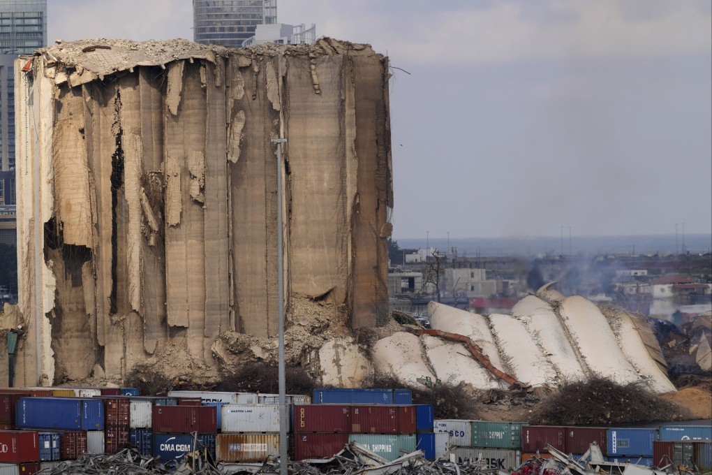 The ruins of the Beirut Port silos’ northern block that withstood a devastating port explosion two years ago collapsed. The smoldering structure fell over on Tuesday morning into a cloud of dust, leaving the southern block standing next to a pile of charred ruins. Photo: AP