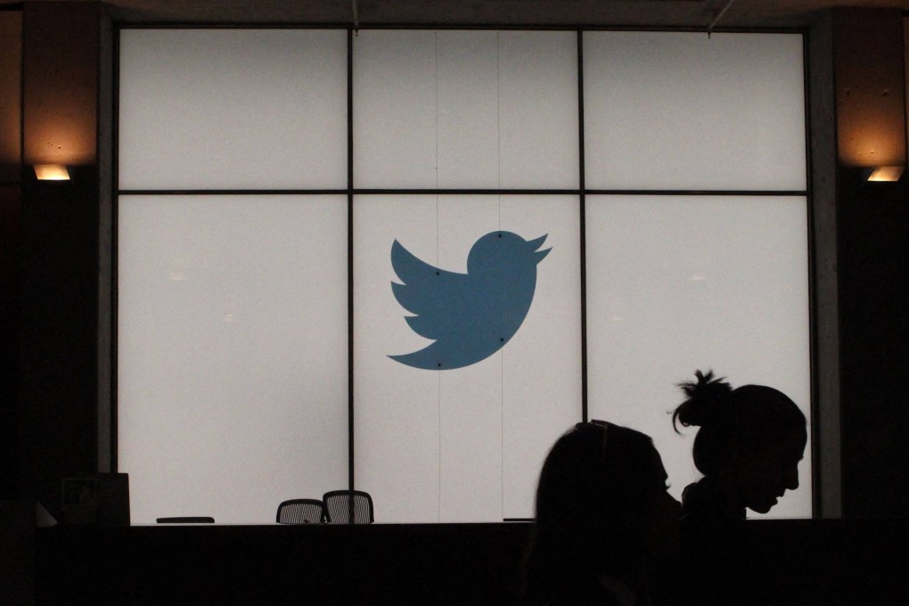 Employees walk past a lighted Twitter logo as they leave the company’s headquarters in San Francisco in August 2019. Photo: AFP