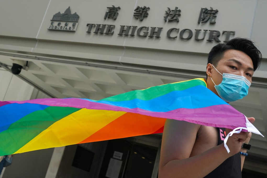 Jimmy Sham Tsz-kit holds rainbow flag outside the High Court in Admiralty. Photo: Felix Wong