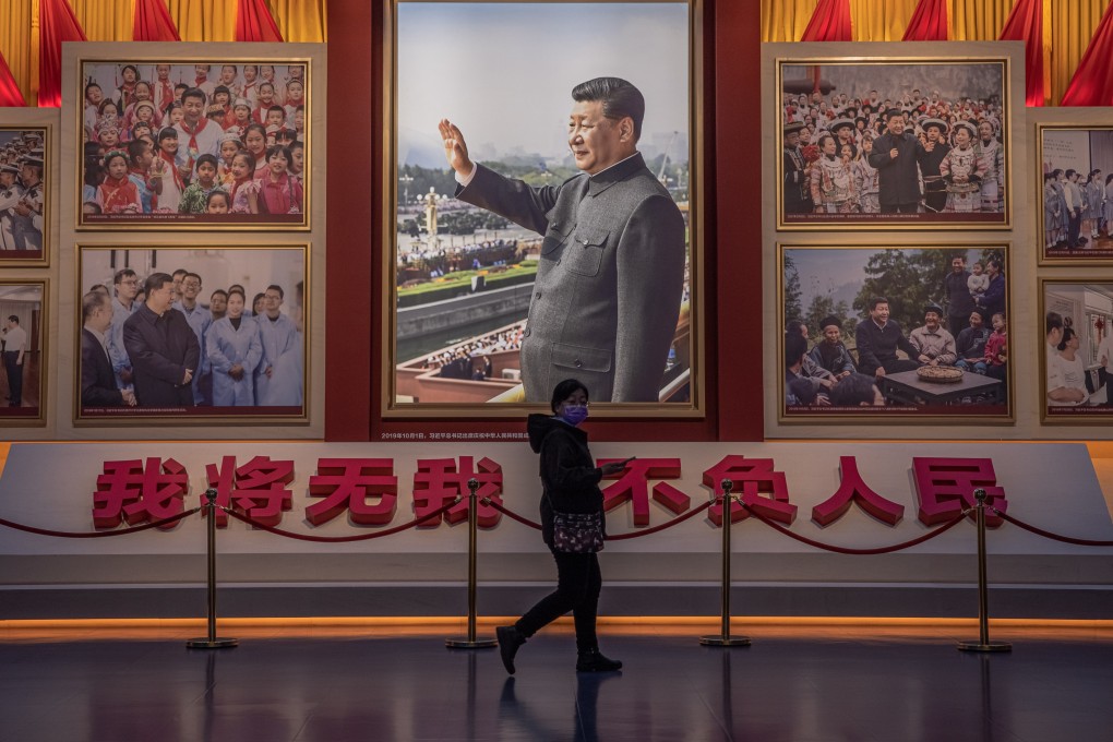 A visitor walks in front of pictures of President Xi Jinping at the Museum of the Communist Party in Beijing. Photo: EPA-EFE