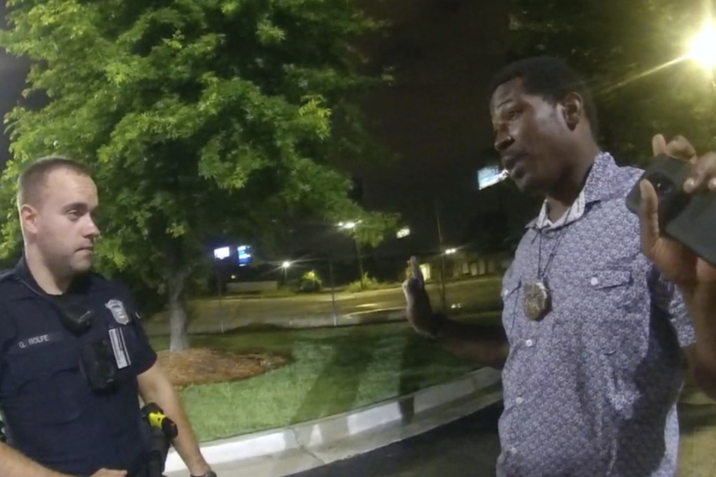 Rayshard Brooks, right, speaks with Officer Garrett Rolfe, left, in the parking lot of a Wendy’s restaurant in Atlanta, June 12, 2020. A specially appointed prosecutor said on Tuesday he will not pursue any charges against the officer who fatally shot Brooks more than two years ago. Photo: Atlanta Police Department via AP, File