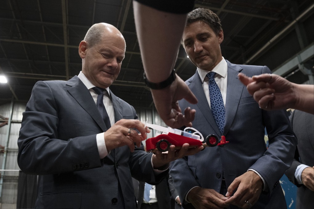 Canadian Prime Minister Justin Trudeau (right) and German Chancellor Olaf Scholz examine a hydrogen powered toy car in Stephenville, Newfoundland and Labrador, on Tuesday. Photo: The Canadian Press via AP