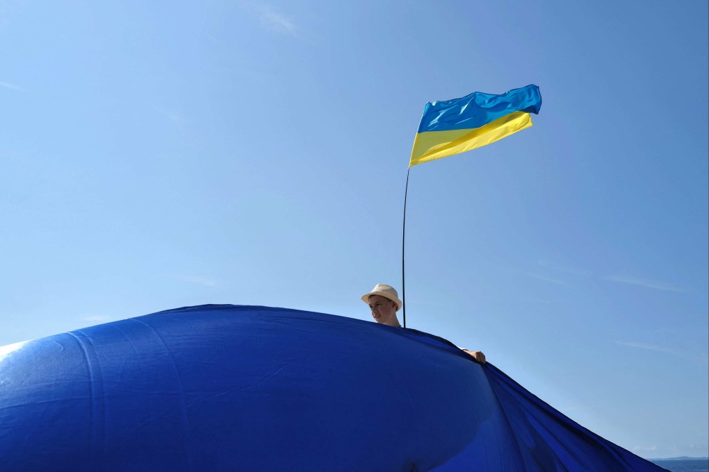A Ukrainian flag is displayed during a march in Nice, France, to mark Ukraine’s Independence Day and the six-month anniversary of the start of Russia’s invasion. Photo: AFP