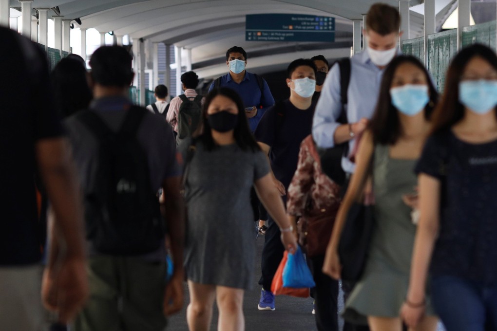 People wear face masks as they leave a railway station in Singapore. From Monday, mask wearing indoors in the city state will be optional, except in healthcare settings and on public transport. Photo: Reuters