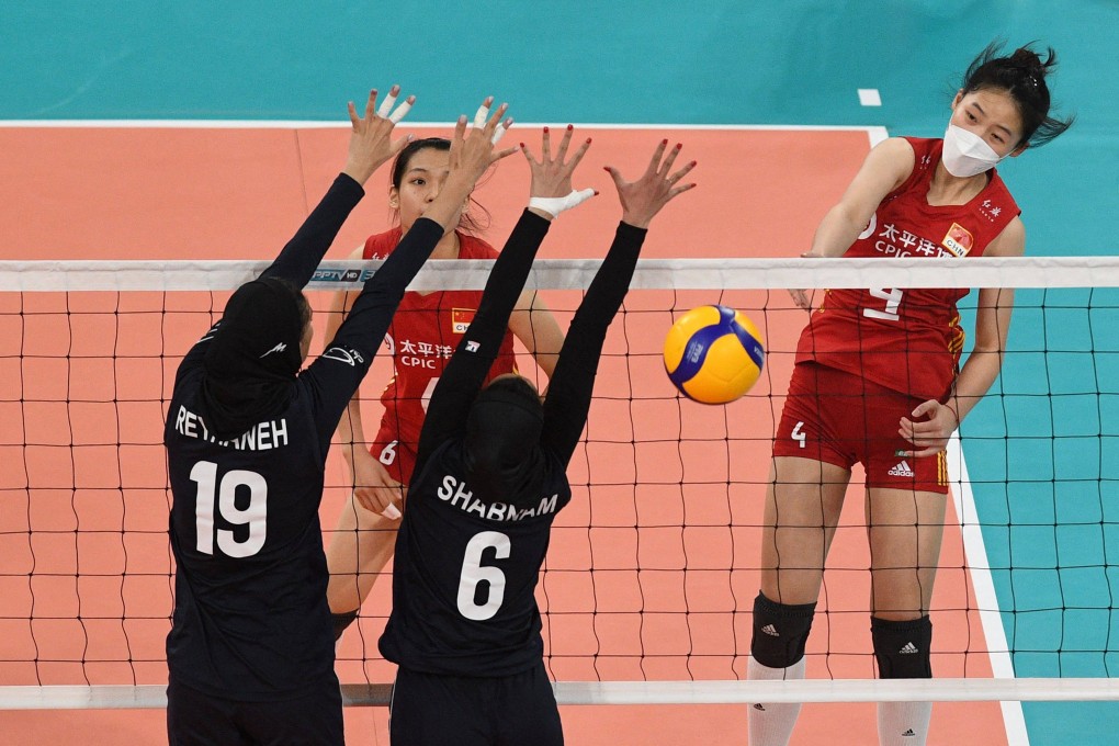 China’s Wang Yifan (right) spikes the ball during the Asian Volleyball Confederation Cup match against Iran in Pasig on August 25, 2022. Photo: AFP