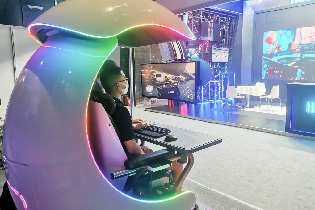A visitor at the World Metaverse Conference in Beijing plays a racing game in a Cooler Master gaming cabin on August 26, 2022. Photo: Coco Feng