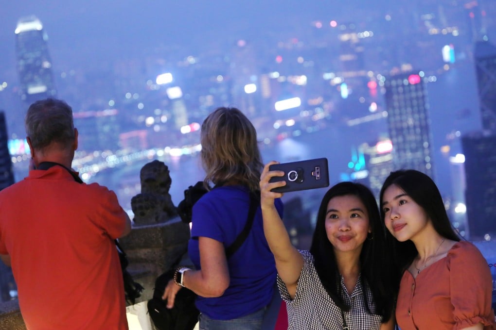 Tourists take photographs at The Peak in September 2019. Photo: Felix Wong