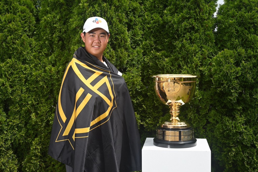 Joohyung Kim with the International Team flag and Presidents Cup. Photo: PGA Tour