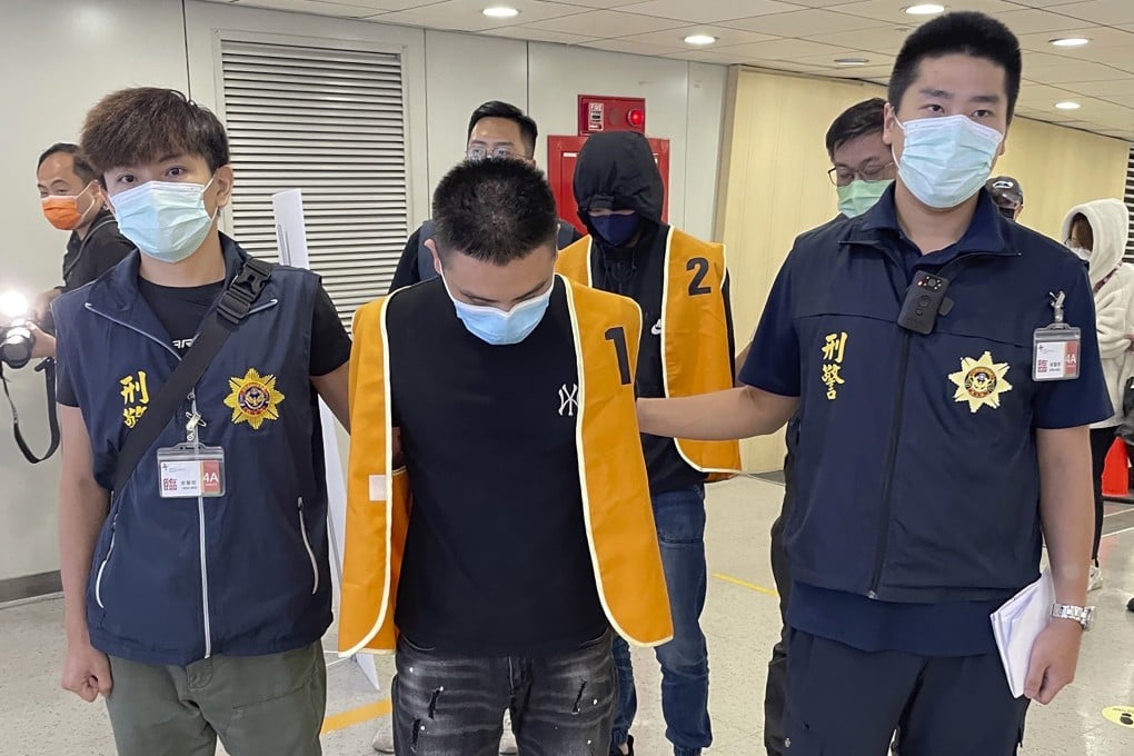 Taiwanese police escort two suspects who were deported from Bangkok earlier this month and are believed to be involved in scam cases in Cambodia. Photo: Taiwan Criminal Investigation Bureau via AP