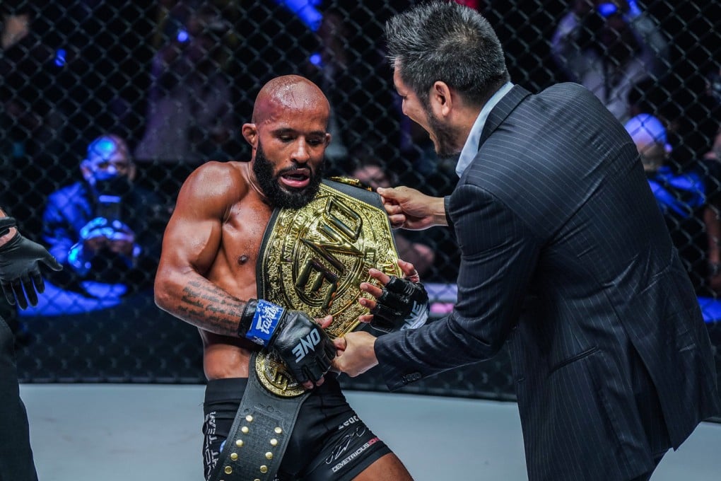 Chatri Sityodtong places the flyweight MMA title on Demetrious Johnson’s shoulder at ONE on Prime Video 1. Photos: ONE Championship