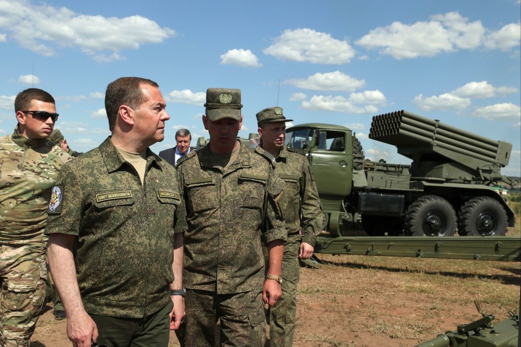 Former Russian president Dmitry Medvedev (second left) visits a military garrison in the Orenburg region on August 5. Photo: Sputnik via AP