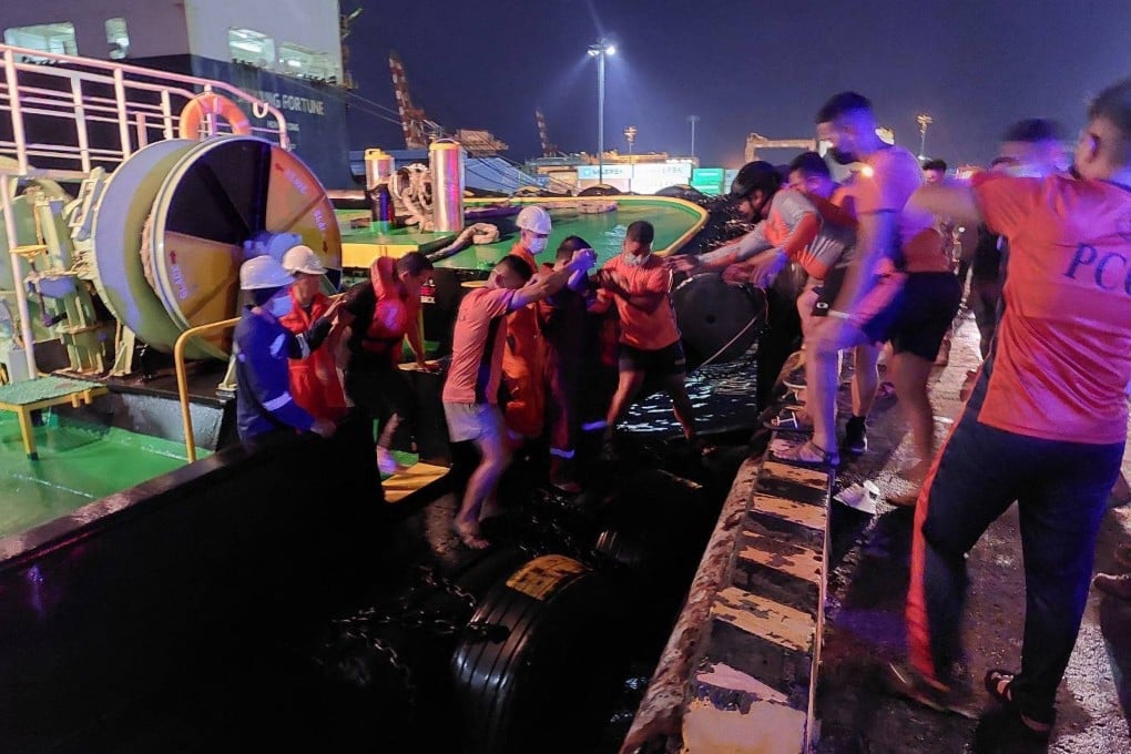 Philippine coastguard personnel assisting rescued passengers after a ferry caught fire off the port of Batangas on Friday. Photo: Philippine coastguard/AFP