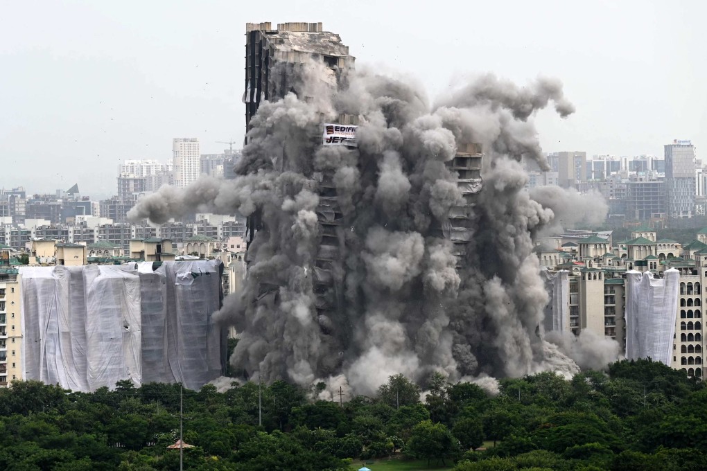 A controlled implosion demolishes the 100-metre-high residential “Twin Towers” on the outskirts of New Delhi on Sunday. Photo: AFP