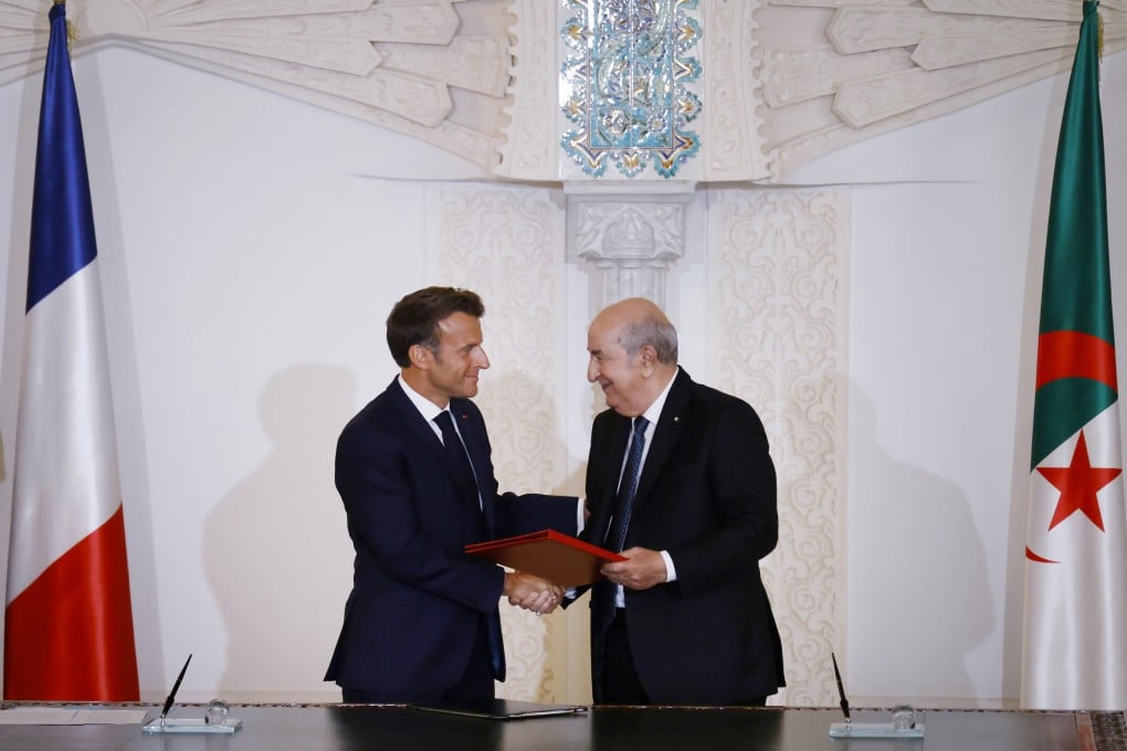 French President Emmanuel Macron, left, and Algerian President Abdelmadjid Tebboune shake hands during a signing ceremony at Algiers airport, Algeria on Saturday. Photo: AP