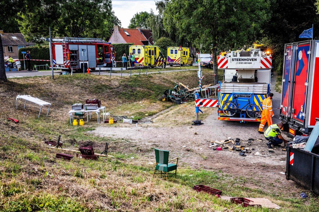 Emergency services attend the scene of an accident after a lorry drove off a wall into a neighbourhood party in Nieuw-Beijerland, Netherlands on Saturday. Photo: ANP / AFP