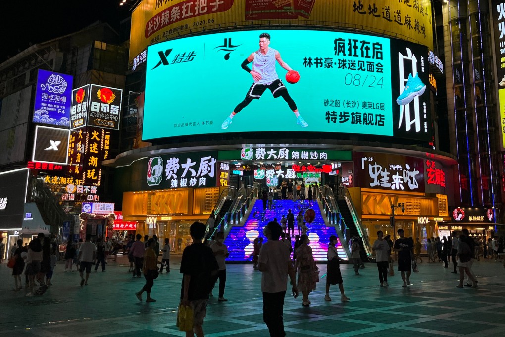 People mingling outside Xtep’s flagship store in Changsha, China. Photo: Weibo