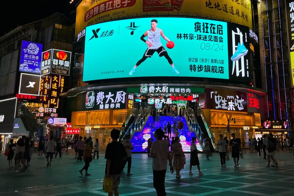 People mingling outside Xtep’s flagship store in Changsha, China. Photo: Weibo