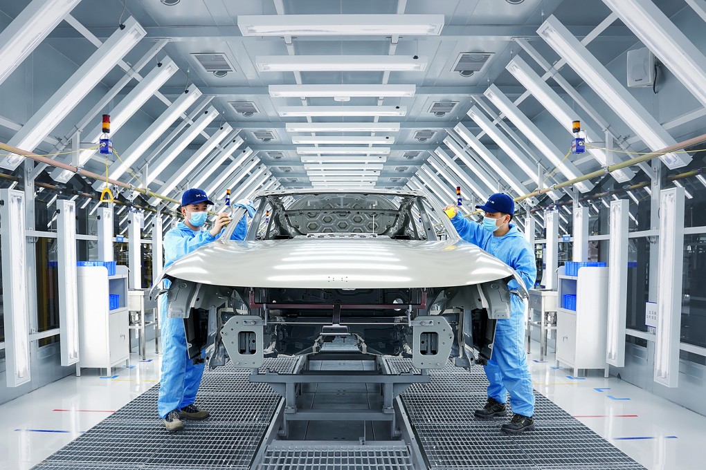 Workers assembling an XPeng EV inside a smart manufacturing factory. Photo: Handout