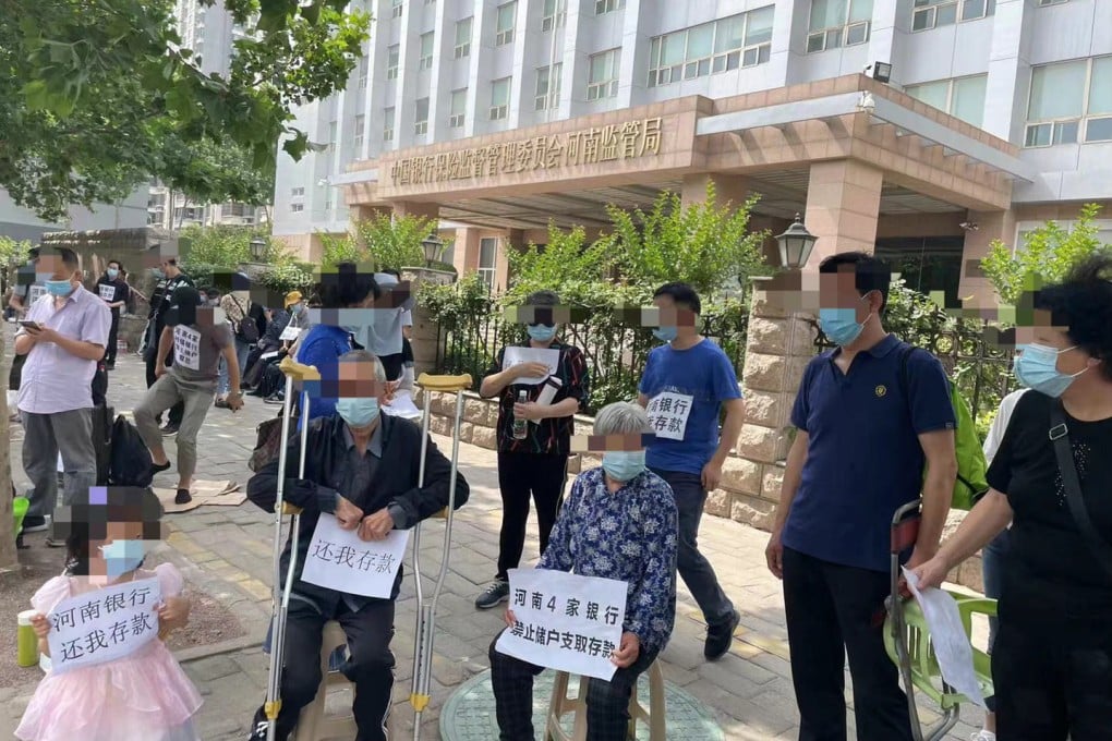 Protesters demonstrate outside the banking regulator in Zhengzhou in May in a banking crisis that continues to unfold. Photo: Weibo