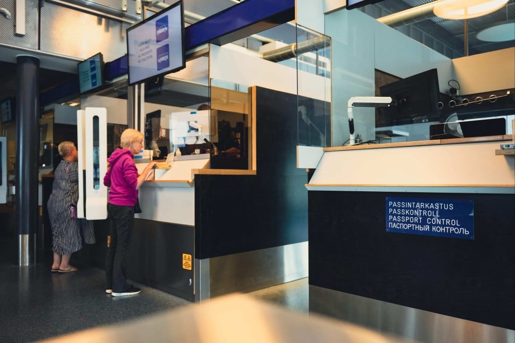 Russian tourists have their passports checked at the Nuijamaa border crossing in Finland. Photo: AFP