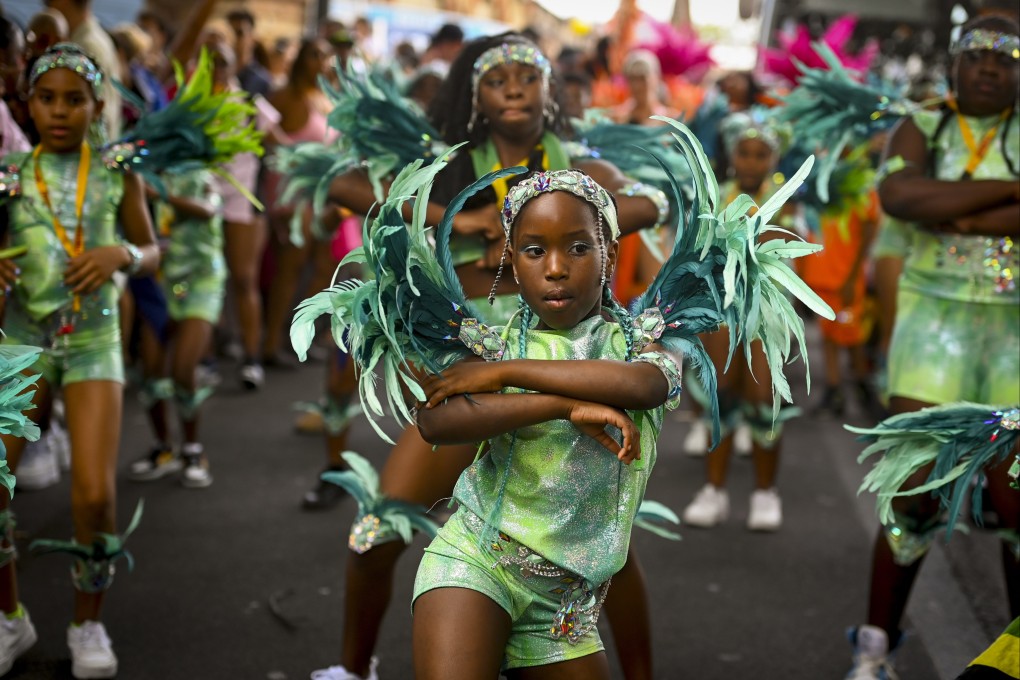 Youths in colourful costumes perform at the Notting Hill Carnival in London, Britain on Sunday. Photo: EPA-EFE