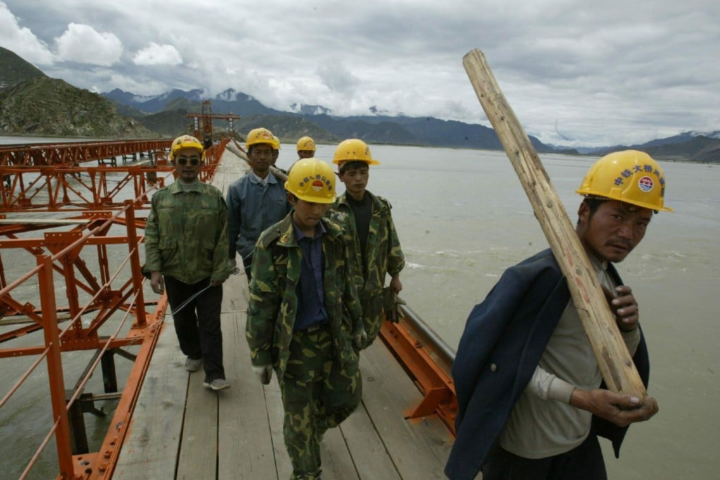 Workers on the Lhasa River railway bridge, part of a multi-billion dollar project to build a railway from China’s Qinghai province up to the Tibetan plateau, are seen in 2003. Plans now exist to link Tibet with Nepal - but it won’t be easily accomplished. Photo: EPA