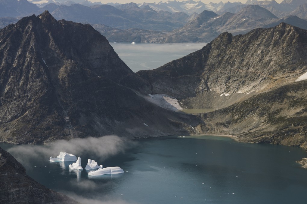Icebergs in eastern Greenland. Even if the entire world stopped burning fossil fuels today, a new study finds the Greenland ice sheet would still lose enough ice to add nearly a foot to rising sea levels. File photo: AP