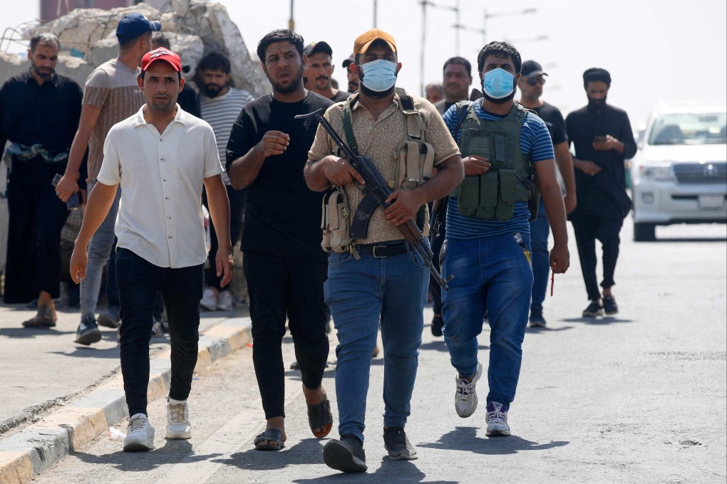 Members of Saraya al-Salam (Peace Brigade), the military wing affiliated with Shiite cleric Moqtada al-Sadr, withdraw from Baghdad’s Green Zone on Tuesday. Photo: AFP
