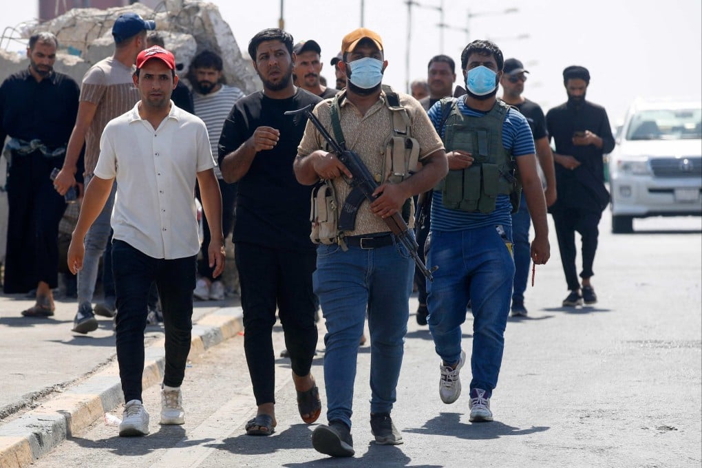 Members of Saraya al-Salam (Peace Brigade), the military wing affiliated with Shiite cleric Moqtada al-Sadr, withdraw from Baghdad’s Green Zone on Tuesday. Photo: AFP