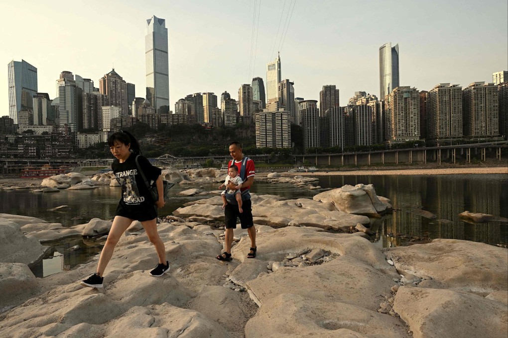 People walk over the dried-up riverbed of the Jialing, a tributary of the Yangtze, in Chongqing. Photo: AFP