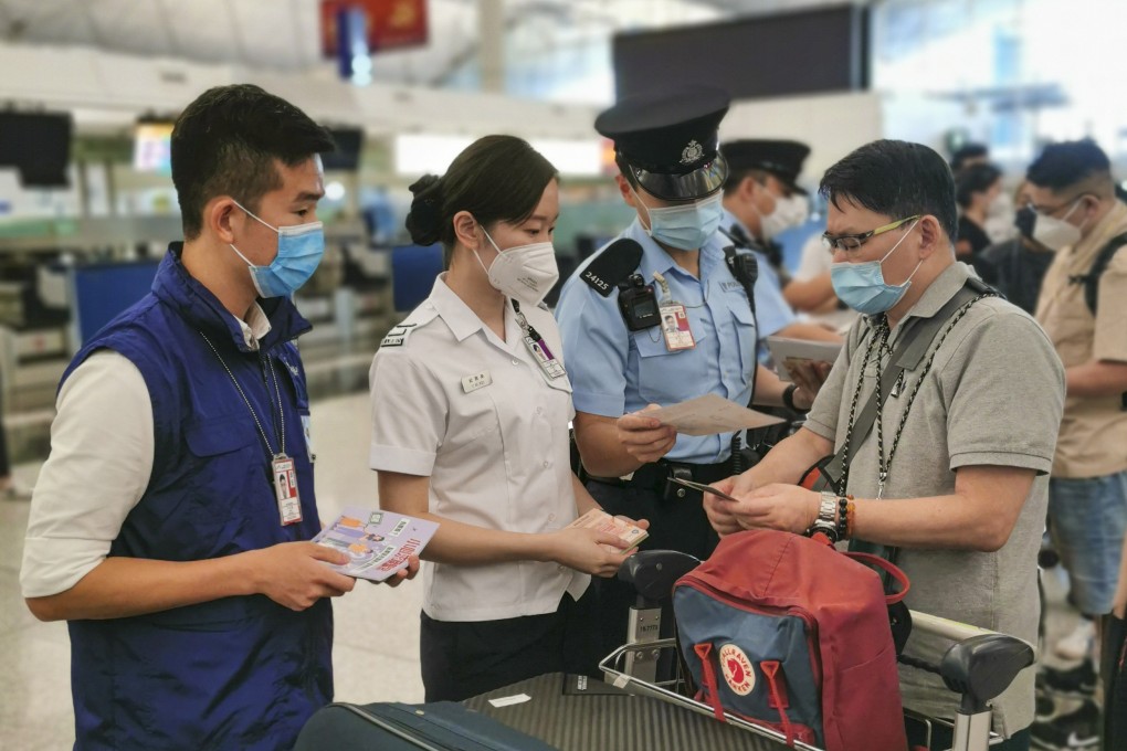 Officers of the Hong Kong Police Force and the Immigration Services Department today (August 18) distribute leaflets at the check-in service counters of Hong Kong International Airport on August 18. Photo: Immigration Services Department Handout