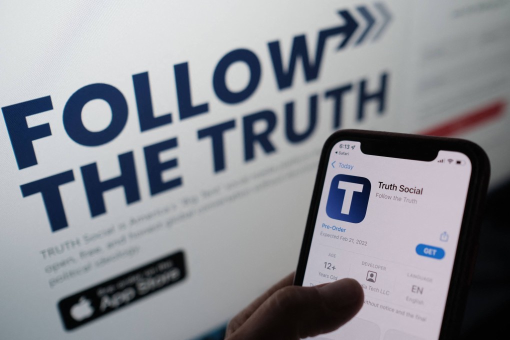 A person checks Apple’s App Store for Truth Social with its website on a computer screen in the background in this illustration photo taken October 20, 2021. Photo: AFP