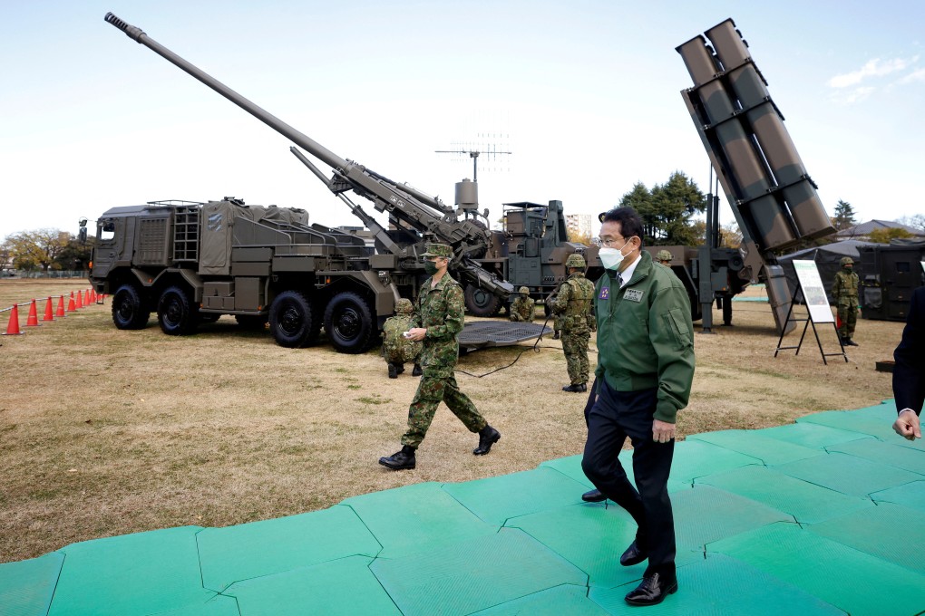 Japan’s Prime Minister Fumio Kishida walks past a howitzer and a surface-to-ship missile launcher as he inspects equipment during a military review last year. Photo: Reuters