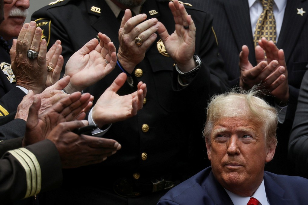 US President Donald Trump listens to applause after signing an executive order at the White House in June 2020. Photo: Reuters
